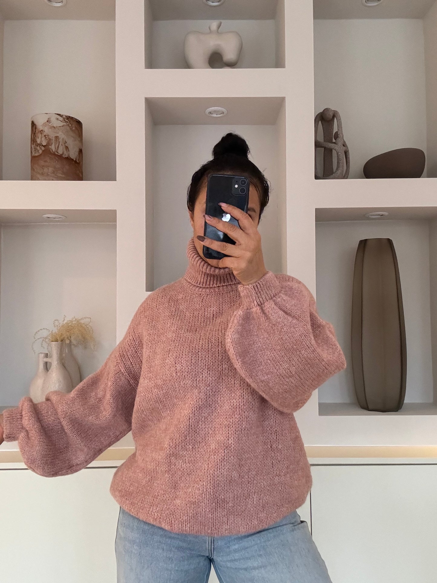 Model draagt de Estée Turtleneck: een zachte, oversized coltrui met een relaxed fit, one size, gemaakt van een comfortabele knit.